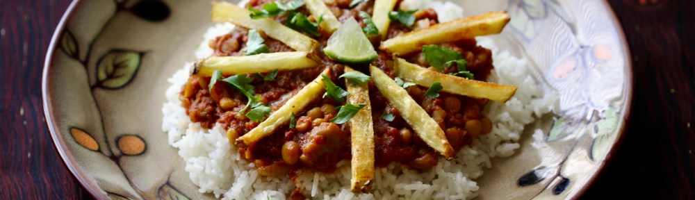 Stew over rice with french fries on top